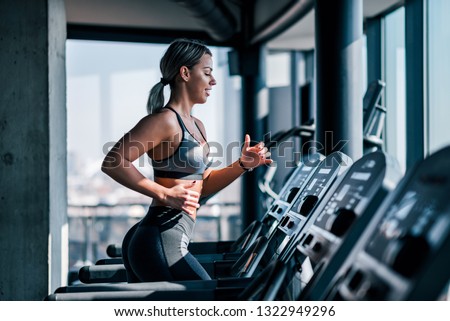 Similar – Image, Stock Photo Young woman in sportswear exercising on a river promenade