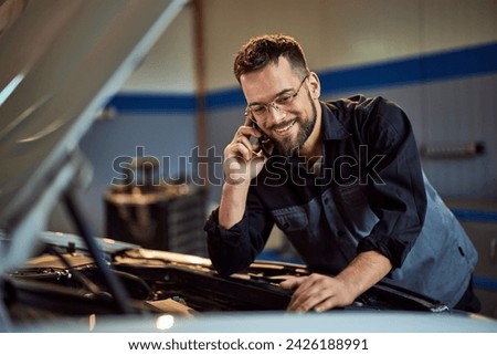 Similar – Image, Stock Photo Busy male mechanic repairing motorcycle seat in workshop