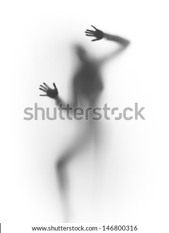 Human body silhouette behind a diffuse surface, hands