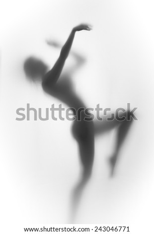 Sexy body silhouette of a dancing woman behind the curtain