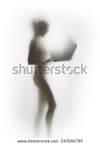 Beautiful slim woman body silhouette with open laptop
