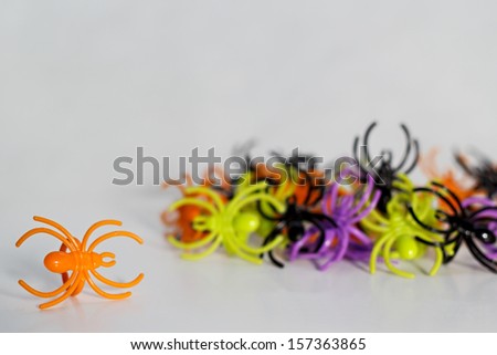 Plastic toy spider rings on white background