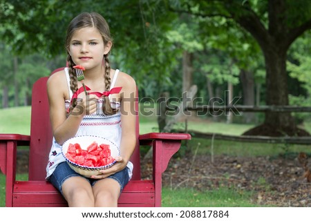 Little girl eating a bite of watermelon off of a fork