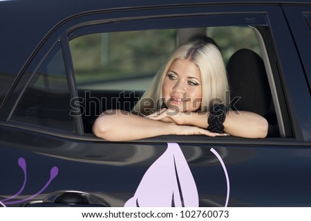 happy young woman in car smiling enjoying car road trip travel vacation. Driving. sexy lady with long blond healthy hair in automobile . spring - summer portrait of tourist girl