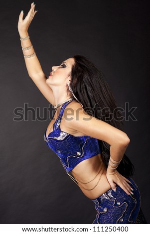 beautiful slim girl belly dancer sexy arabian turkish oriental professional artist in carnival shining costume with long healthy glossy hair. brunette woman dancing. exotic star of bellydance