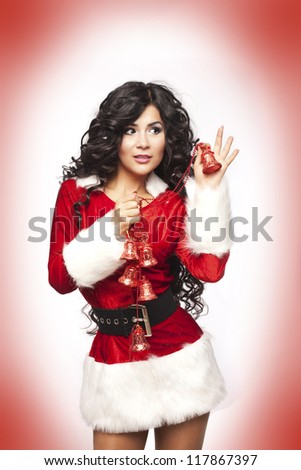 Beautiful christmas woman in Santa Clause costume with extra long curly hair. winter portrait of sexy santa girl wondering. attractive new year and xmas party lady wait for a miracle. series in studio