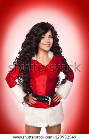 Beautiful christmas woman in Santa Clause costume with extra long curly hair. winter portrait of sexy santa girl wondering. attractive new year and xmas party lady wait for a miracle. series in studio