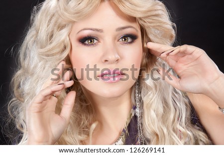 Fashion Blonde Woman with bright evening makeup and hairstyle in studio. Blond Hair. Hairstyle. Haircut. Makeup. Clean healthy skin. Alluring girl posing. Stylish blond lady with manicure. portrait