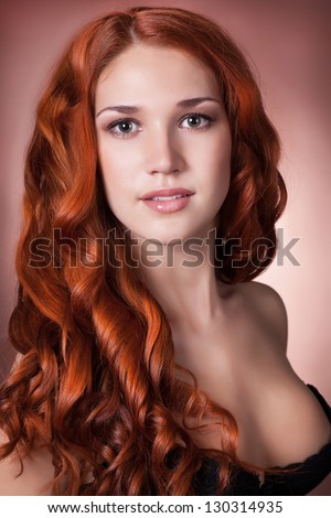 Red-haired Fashion Woman with perfect skin healthy glossy hair natural makeup in lingerie. Girl with curly haircut. Health and beauty products. Skincare. Spa. Beauty Model. Alluring happy lady smiling
