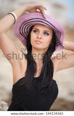 Happy fashion woman on beach in trendy summer hat relaxing near sea. Sexy brunette girl beauty model happy joyful laughing outdoors on nature . Summer beach vacation holidays.  travel getaway concept