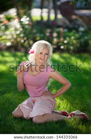 Ice cream woman girl eating cone icecream on summer nature vacation smiling happy and cute joyful and cheerful sexy blonde. Alluring woman eating vanilla calorie ice cream dessert outdoors in park