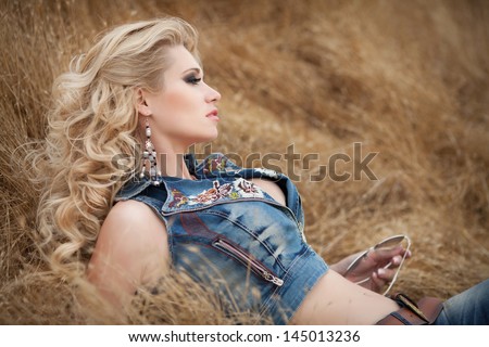 Happy beautiful woman smiling outdoors on country nature. pretty blonde girl in hand made jewelry. Healthy attractive woman smiling. Makeup curly hairstyle. Summer girl face