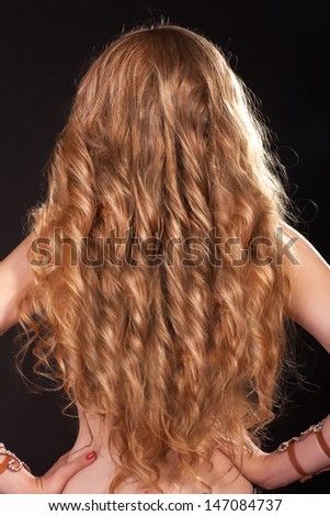 Beautiful blonde hair girl with extra long curly healthy silk Hair. Beauty and spa. Perfect blonde hair woman. Long curly hair. hair care. woman gorgeous hairstyle in studio. Healthy Long Curly Hair