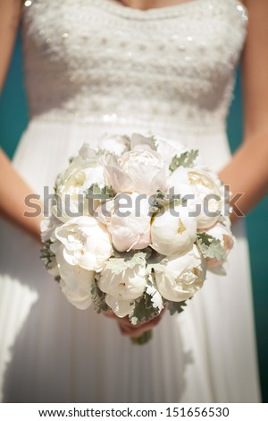 bride with wedding bouquet  peony flowers. Bridal flowers at wedding day. beautiful bouquet of marriage flowers. wedding decoration.beige and white wedding flowers. peony bouquet at summer wedding