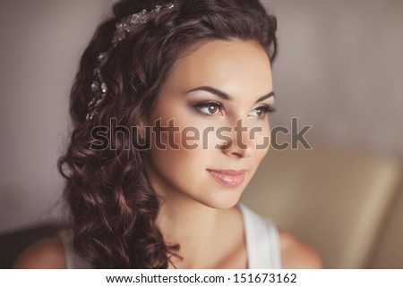 Beautiful bride with wedding makeup and hairstyle, attractive newlywed woman have final preparation for wedding. Bride waiting groom. Happy newlywed. Marriage. Wedding day moments. Bride makeup.