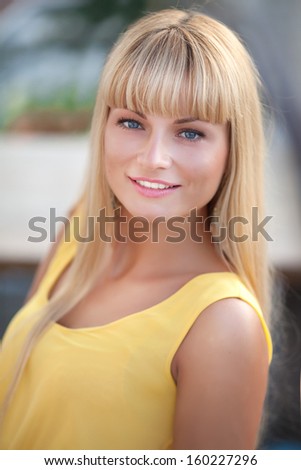 Portrait Of Young Smiling Beautiful Woman student outdoors. Attractive teenager girl happy smile. Healthy sensual woman natural beauty. Spring - summer.