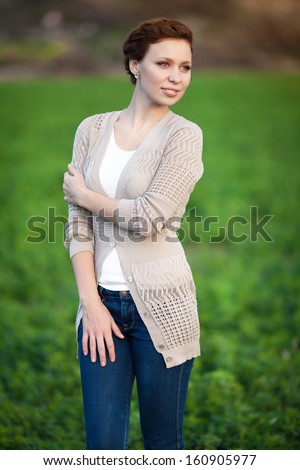 Beautiful autumn woman happy smiling outdoors portrait. Excited happy fall woman smiling joyful in autumn park. Autumn girl in woolen accessories outside.