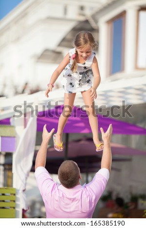 Happy family outdoors, father and daughter having fun. Man and little girl beautiful family. Father playing with daughter baby girl.