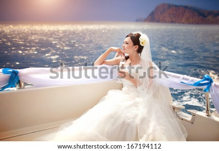 Beautiful Bride on yacht at wedding day. Luxury wedding. Newlywed woman outdoors.