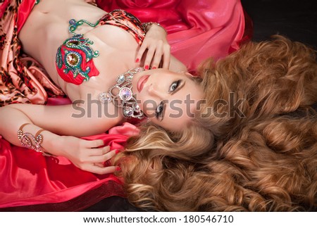 Beauty Portrait Woman Blonde girl with long curly hair,Glamour Makeup. Gold Jewelry. Hairstyle. Luxury lady. studio, isolated on black. Series.