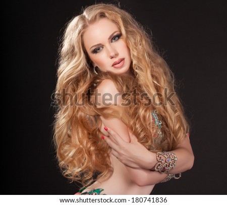 Beauty Portrait Woman jewelry, Blonde girl with long curly hair,Glamour Makeup. Gold Jewelry. Hairstyle. Luxury lady. Oriental bellydancer. studio, isolated on black. Series.