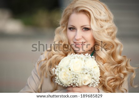 Beautiful Bride with wedding makeup and hairstyle. Wedding day woman with marriage flowers. Happy blonde bride outdoor. Sunset.
