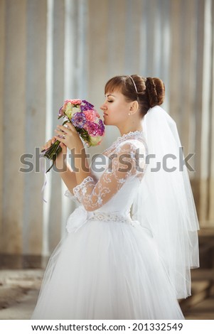 Beautiful young bride with wedding makeup and hairstyle, attractive newlywed woman wedding flowers. Happy Bride waiting groom. Marriage Wedding day moment. Bride portrait. soft tonality