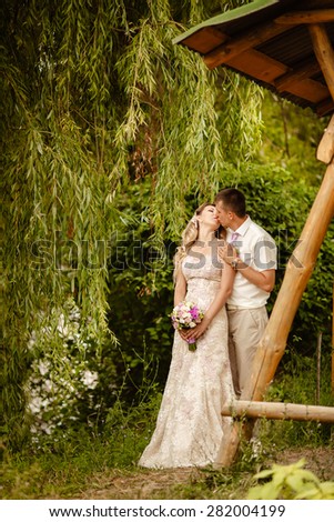 Bride and groom wedding portrait outdoors newlyweds loving couple kissing marriage bridal flowers, kissing man and woman at wedding day, selective focus, series