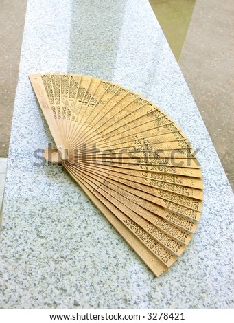 Fan laying on a granite plate and shined by a daylight