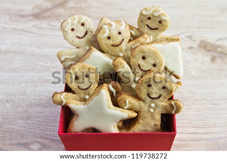 Christmas ginger biscuits in the red box on the wooden background