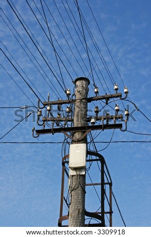 Electricity supply cables connected to a wooden pole complete with insulators.