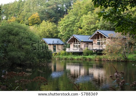 wood cabins in forest park with lake frontage