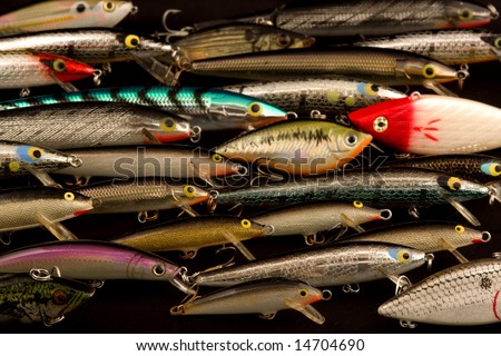 This is a collection of fishing lures going in the same direction except for one lure \
