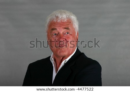 mature man well-dressed looking smug