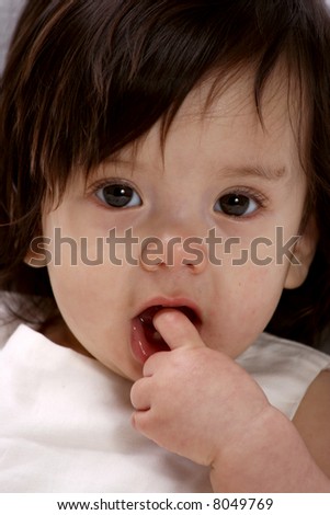 Cute baby with her finger in her mouth