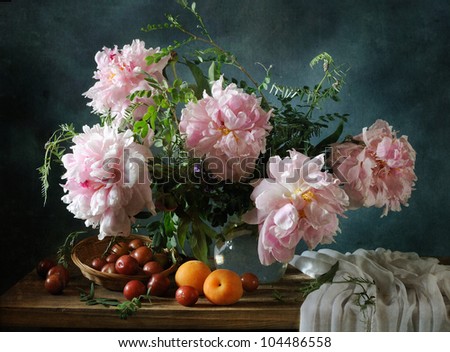 Still life with a beautiful bouquet of peonies and fruit