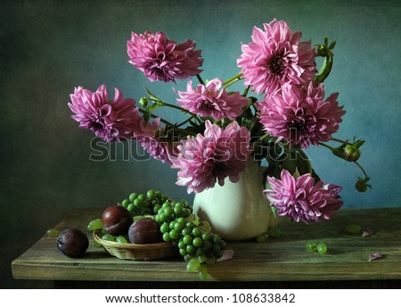 Still life with a bouquet of dahlias and plums
