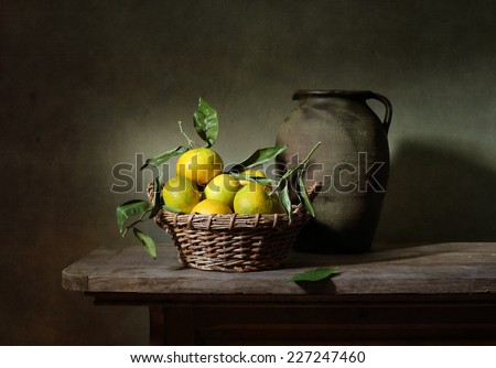 Still life with mandarins and an old jar