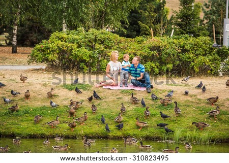 Family feeding birds in the park