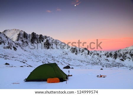 Camping before sunrise in winter time, Retezat mountains, Romania
