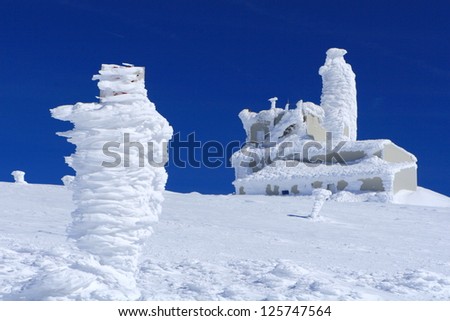 Building covered by frozen snow, Tarcu mountains, Romania