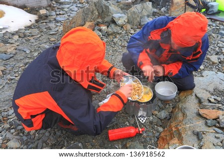 Mountaineers cooking during bad weather