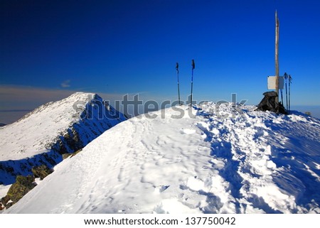 Mountain summits under white snow and blue sky, Romania