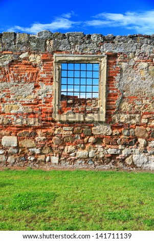 Barred window and blue sky beyond