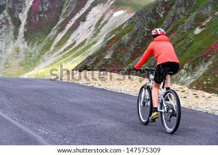 Woman cycling on mountain road