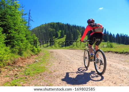 Women during mountain biking trip on difficult alpine road