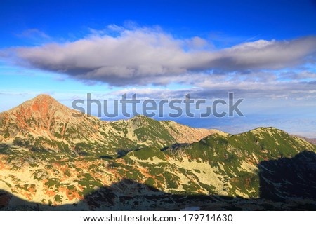 Remote mountains under white clouds in the morning