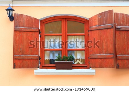 Vintage window with wood shutters wide open
