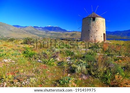 Stone made wind mill on the sunny hills of Greece