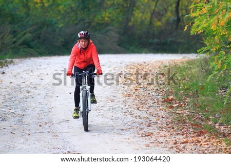 Family riding bikes on gravel road in the forest